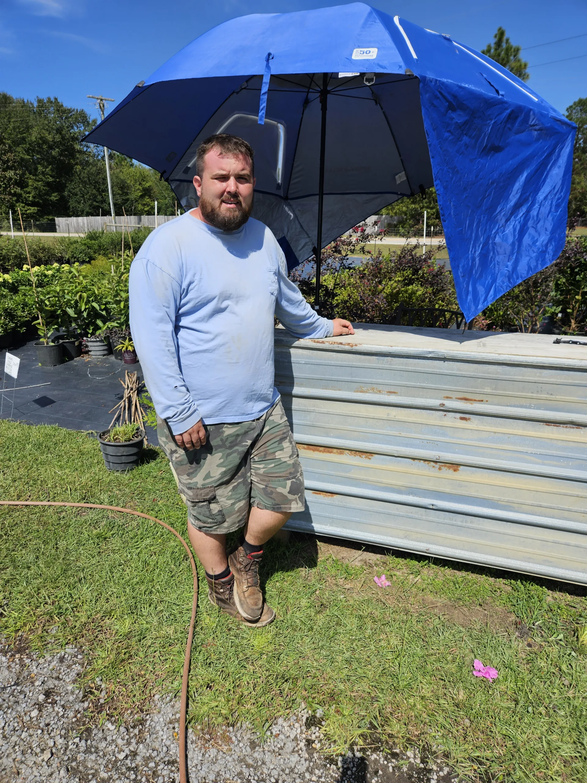 Local Boy owner, Trent, standing at the outdoor counter of his nursery.